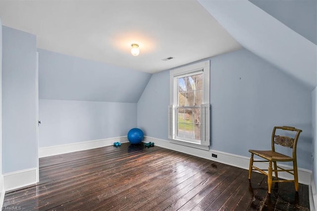 bonus room with visible vents, baseboards, vaulted ceiling, and hardwood / wood-style flooring