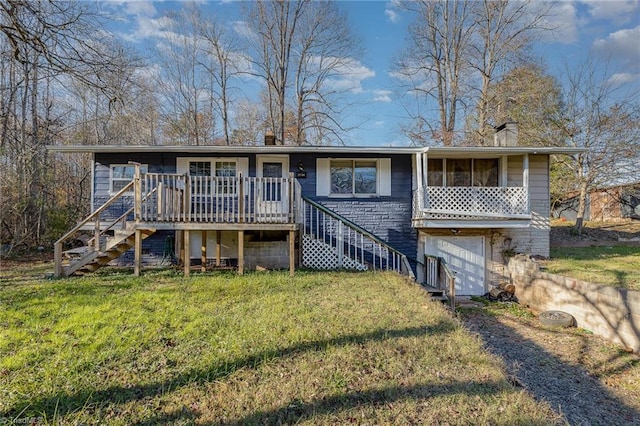 rear view of property with a yard and a deck