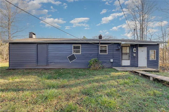 rear view of house with a yard