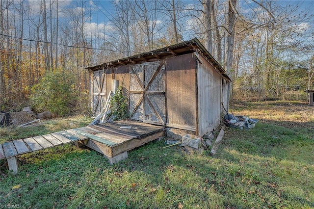 view of outbuilding with a yard