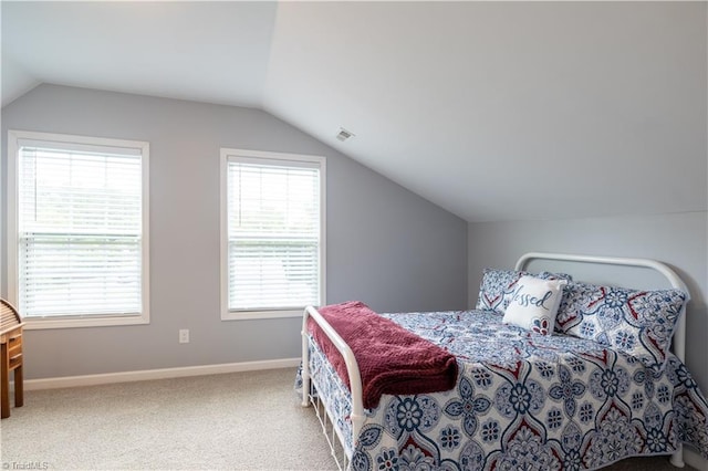 bedroom featuring carpet floors and vaulted ceiling