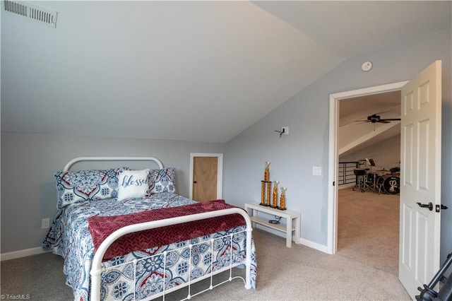 carpeted bedroom with lofted ceiling