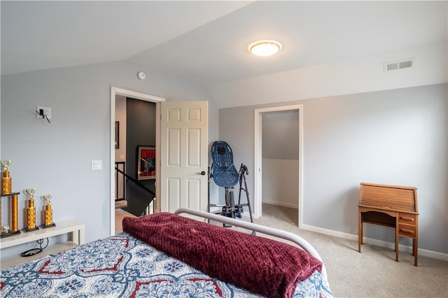 bedroom with vaulted ceiling and carpet flooring