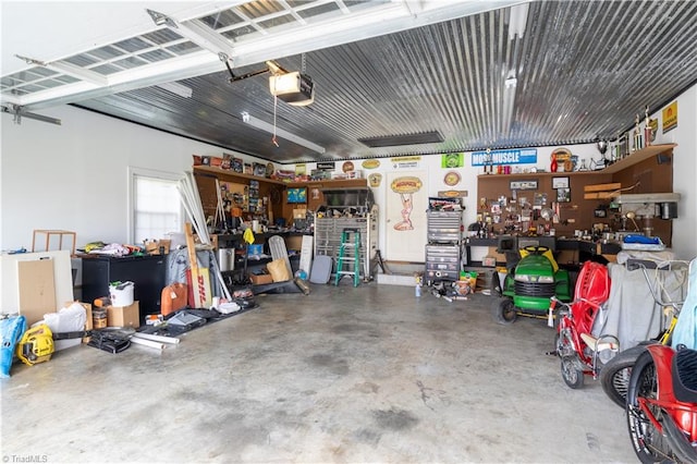 garage with a workshop area and a garage door opener