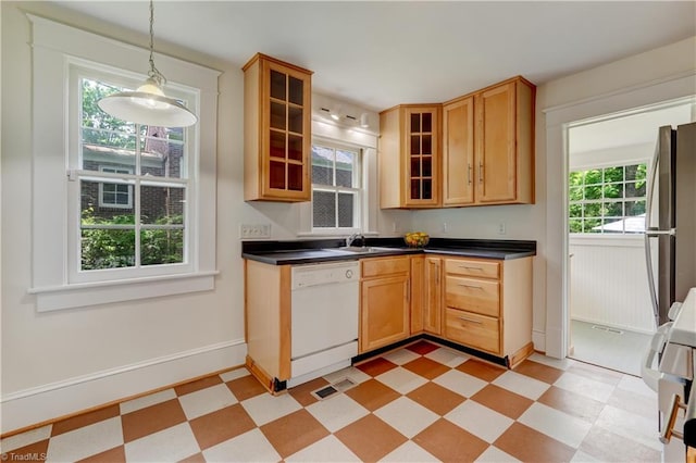 809 Simpson St, Greensboro, NC 27401 - kitchen with white dishwasher, light flooring, dark countertops, and freestanding refrigerator