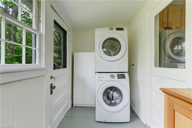 809 Simpson St, Greensboro, NC 27401 - clothes washing area featuring stacked washer / dryer and cabinet space