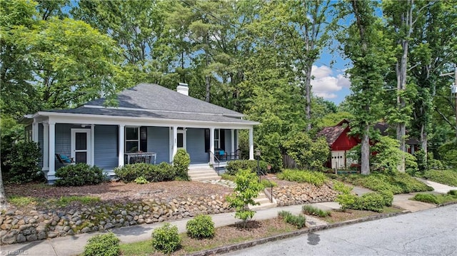 809 Simpson St, Greensboro, NC 27401 - view of front facade with a porch, a chimney, and roof with shingles