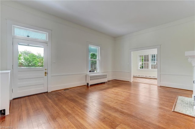 809 Simpson St, Greensboro, NC 27401 - entrance foyer with radiator heating unit, baseboard heating, and light wood-type flooring