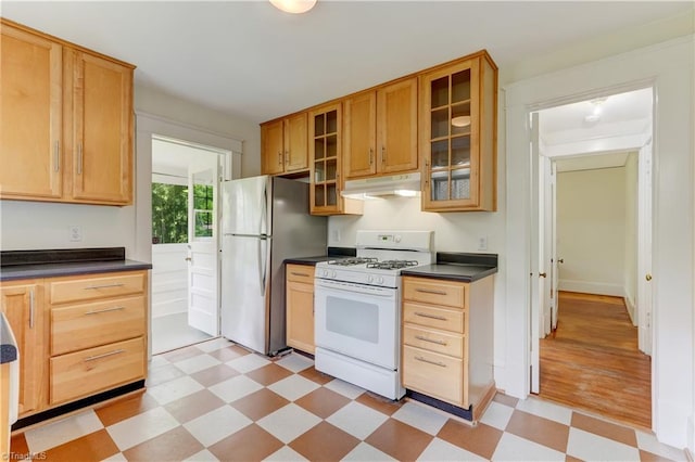 809 Simpson St, Greensboro, NC 27401 - kitchen with white appliances, light flooring, under cabinet range hood, and dark countertops