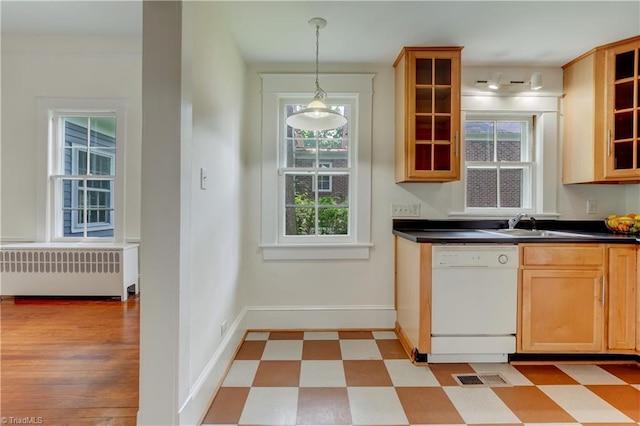 809 Simpson St, Greensboro, NC 27401 - kitchen featuring white dishwasher, radiator, dark countertops, and baseboards