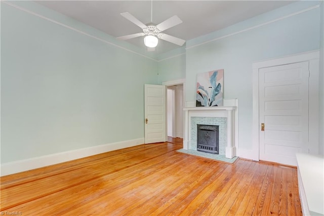 809 Simpson St, Greensboro, NC 27401 - unfurnished living room with light wood-style flooring, a fireplace, ceiling fan, and baseboards