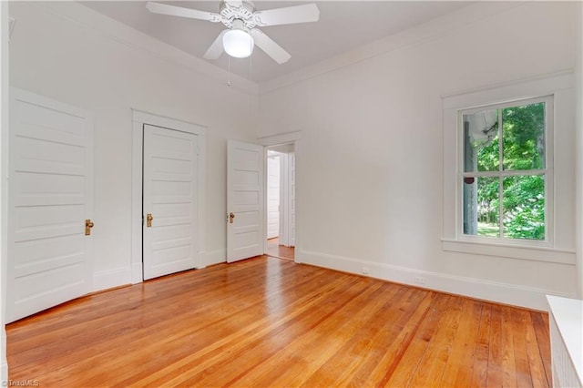 809 Simpson St, Greensboro, NC 27401 - unfurnished bedroom with light wood-type flooring, baseboards, crown molding, and a ceiling fan