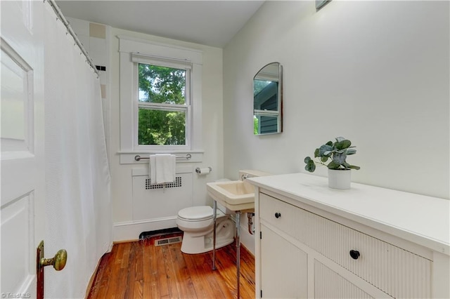 809 Simpson St, Greensboro, NC 27401 - full bath with hardwood / wood-style flooring, toilet, and a shower with curtain