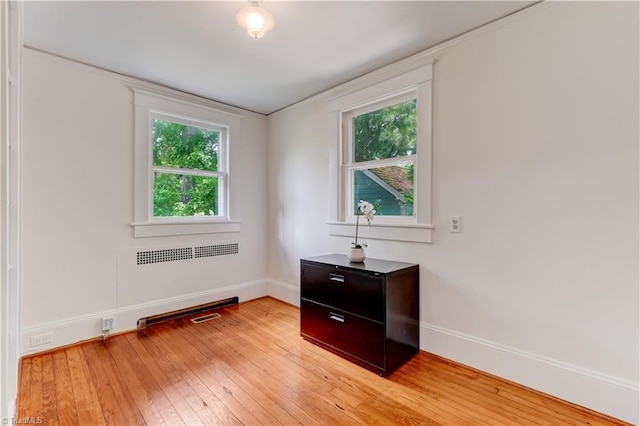 809 Simpson St, Greensboro, NC 27401 - unfurnished room featuring plenty of natural light, radiator, light wood-type flooring, and baseboards