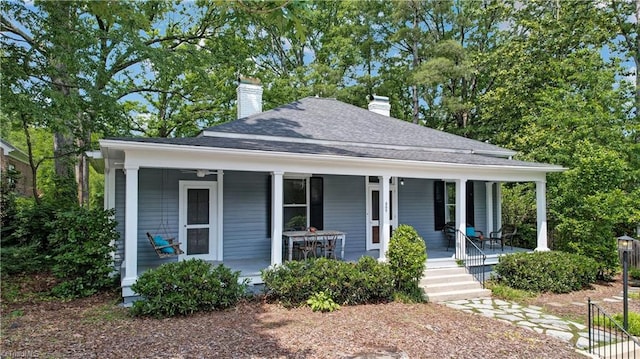 809 Simpson St, Greensboro, NC 27401 - view of front of property with a chimney, covered porch, and a shingled roof