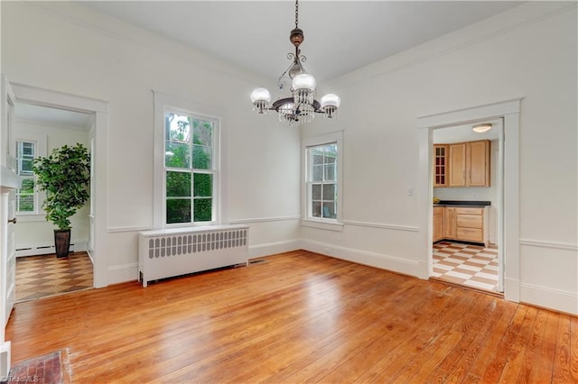 809 Simpson St, Greensboro, NC 27401 - unfurnished dining area with radiator, a chandelier, healthy amount of natural light, light wood-style flooring, and crown molding