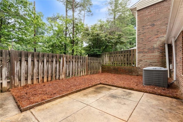 2704 Saint Johns Pl, Winston-Salem, NC 27106 - fenced backyard featuring central AC, a patio area, and view of wooded area