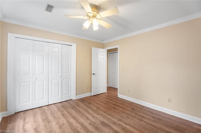 2704 Saint Johns Pl, Winston-Salem, NC 27106 - unfurnished bedroom with baseboards, wood finished floors, ornamental molding, a closet, and ceiling fan
