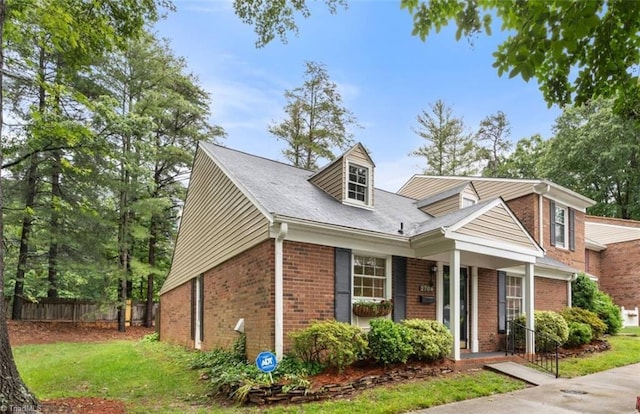2704 Saint Johns Pl, Winston-Salem, NC 27106 - cape cod home featuring brick siding and a porch