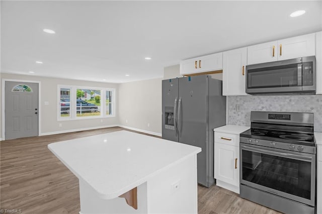 705 Laurel Ave, Lexington, NC 27292 - kitchen with stainless steel appliances, white cabinetry, light wood-style flooring, light countertops, and recessed lighting