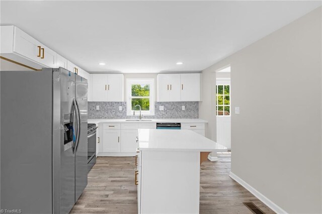 705 Laurel Ave, Lexington, NC 27292 - kitchen featuring stainless steel appliances, light wood-style flooring, decorative backsplash, plenty of natural light, and recessed lighting