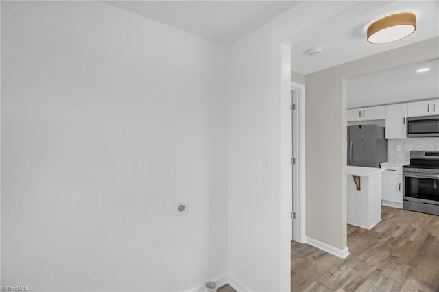 705 Laurel Ave, Lexington, NC 27292 - spare room with light wood finished floors, baseboards, and a smoke detector
