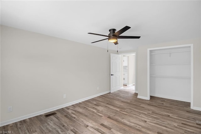 705 Laurel Ave, Lexington, NC 27292 - unfurnished bedroom with wood finished floors, baseboards, ceiling fan, and a closet