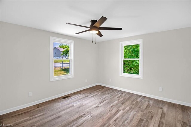 705 Laurel Ave, Lexington, NC 27292 - unfurnished room featuring plenty of natural light, wood finished floors, ceiling fan, and baseboards