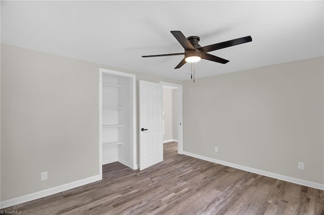 705 Laurel Ave, Lexington, NC 27292 - unfurnished bedroom featuring wood finished floors, a closet, baseboards, and ceiling fan