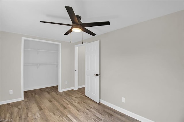 705 Laurel Ave, Lexington, NC 27292 - unfurnished bedroom featuring baseboards, wood finished floors, a closet, and ceiling fan