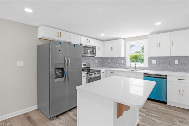 705 Laurel Ave, Lexington, NC 27292 - kitchen featuring stainless steel appliances, a sink, light wood-type flooring, decorative backsplash, and recessed lighting