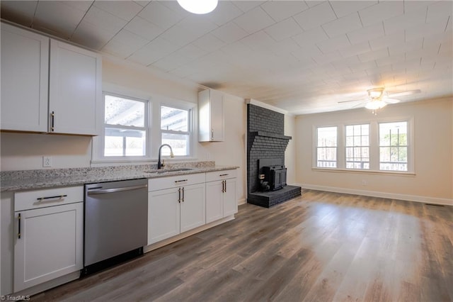 kitchen with a sink, stainless steel dishwasher, wood finished floors, white cabinets, and ceiling fan