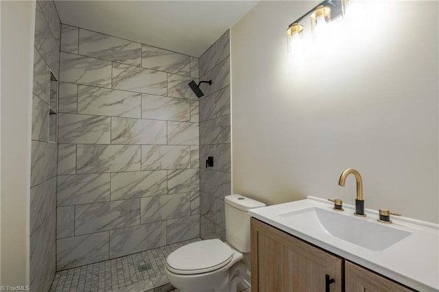 full bathroom with toilet, vanity, and a tile shower