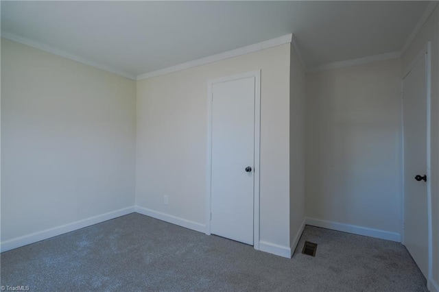 unfurnished bedroom featuring visible vents, baseboards, and ornamental molding