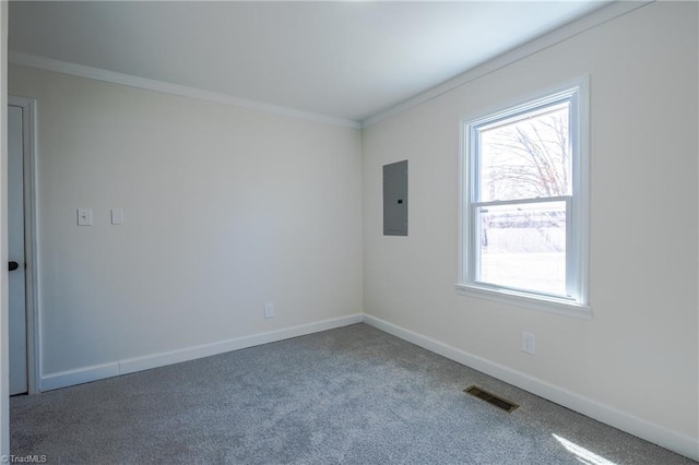 carpeted empty room with electric panel, visible vents, crown molding, and baseboards