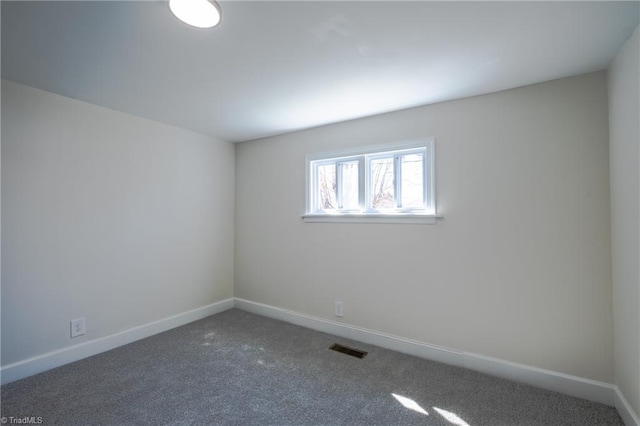 carpeted empty room with baseboards and visible vents