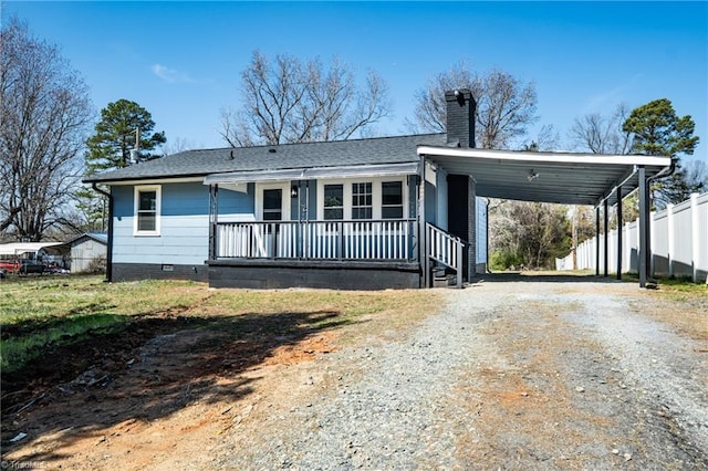 view of front of property featuring fence, a porch, roof with shingles, a chimney, and driveway