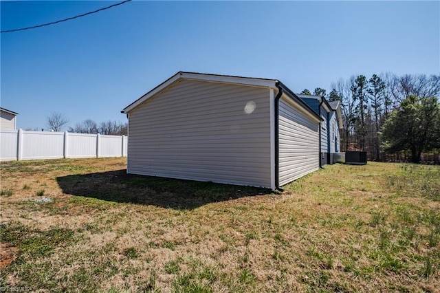 view of home's exterior featuring a yard and fence