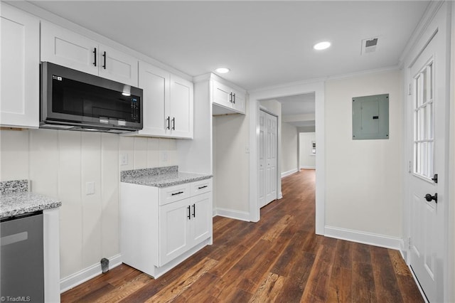 kitchen with dark hardwood / wood-style floors, light stone countertops, white cabinetry, and electric panel