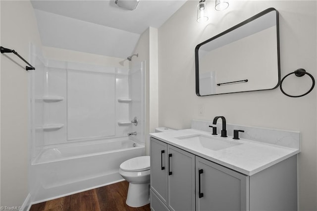 full bathroom with shower / bath combination, vanity, wood-type flooring, and toilet