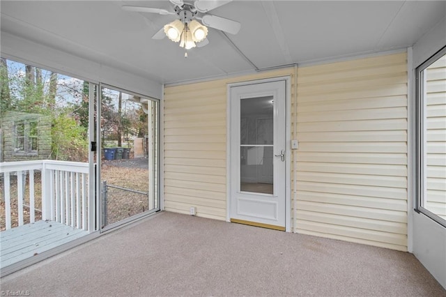 unfurnished sunroom featuring ceiling fan