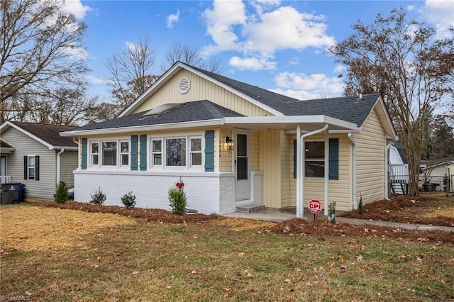 bungalow-style home featuring a front lawn