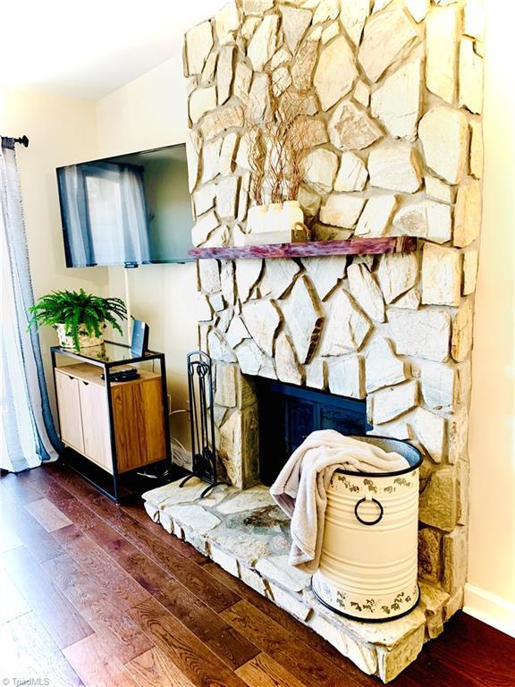 301 Pinnacle Inn Rd Unit 4315, Beech Mountain, NC 28604 - detailed view of wood finished floors, baseboards, and a stone fireplace