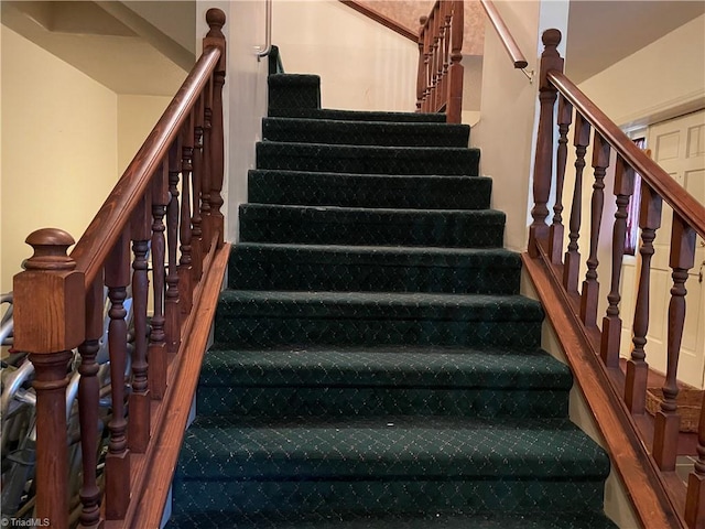 stairs featuring wood finished floors