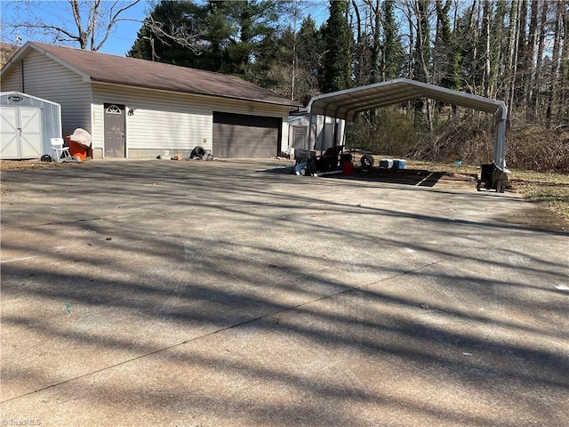 view of home's exterior with a garage, aphalt driveway, a carport, and an outdoor structure