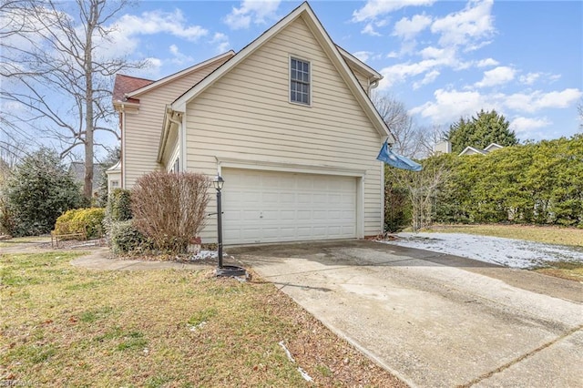 view of property exterior with a garage, driveway, and a yard