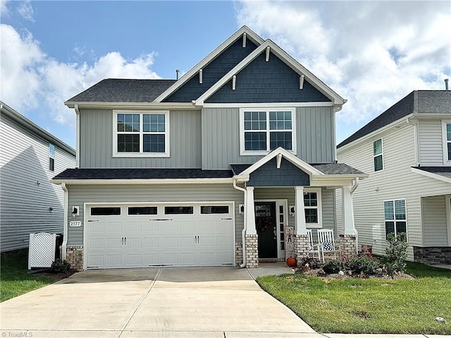 craftsman-style house featuring a porch, a garage, and a front lawn