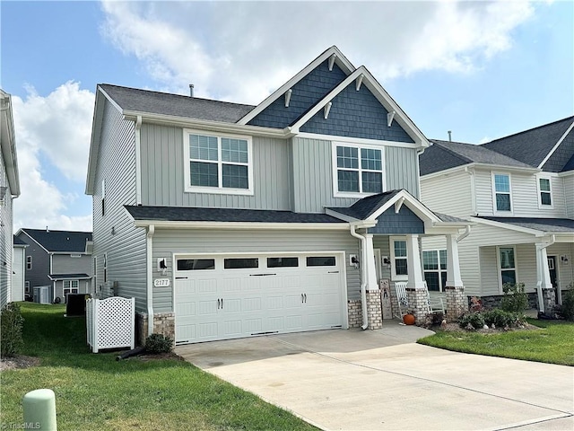 craftsman-style house featuring a front lawn and a garage