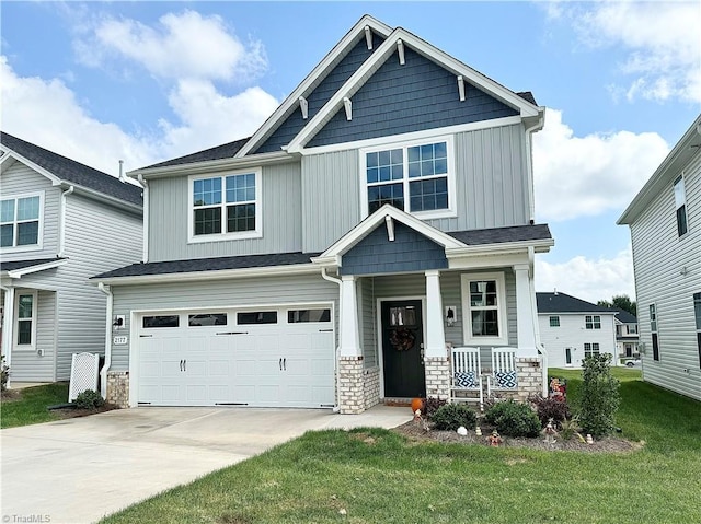 craftsman-style home with covered porch, a garage, and a front lawn