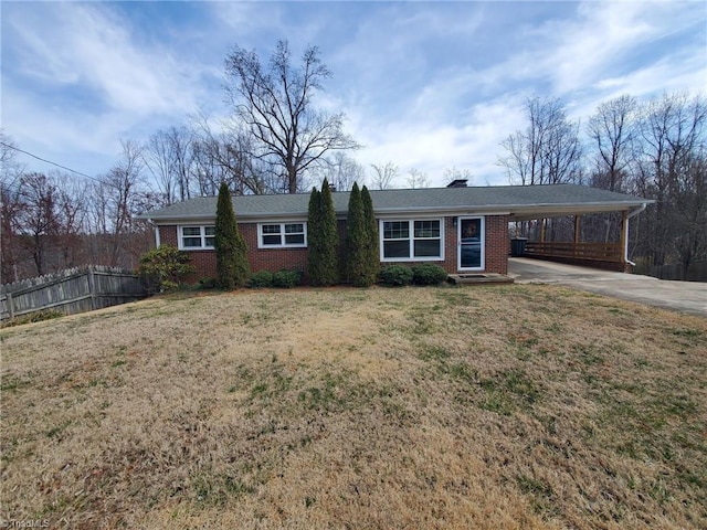 ranch-style home with fence, a carport, concrete driveway, a front lawn, and brick siding